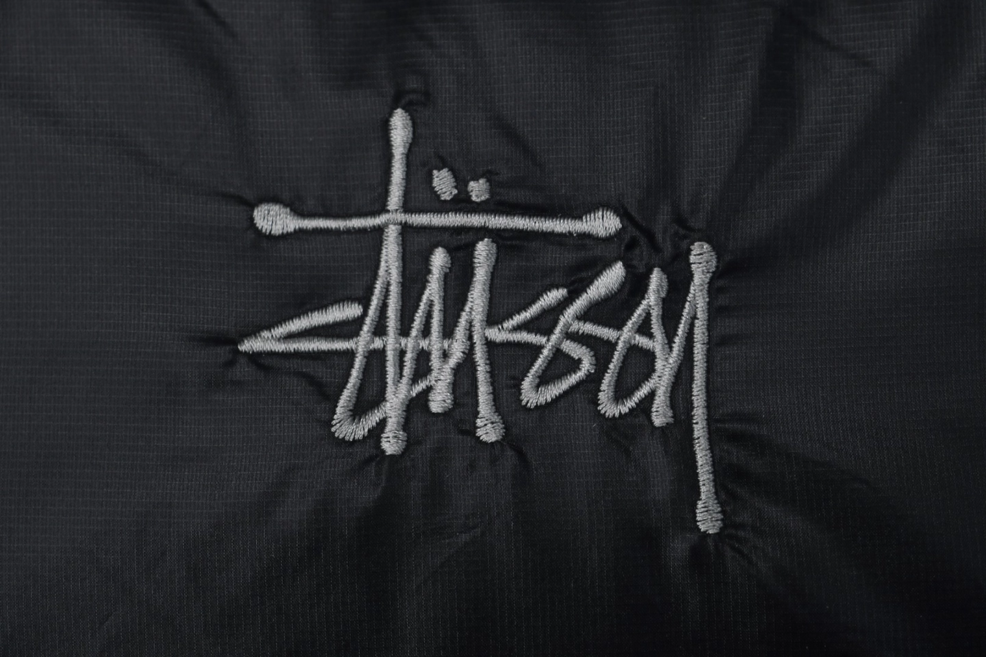 Stussy-Classic-Logo-Hooded-Down-Jacket-–-BlackGrey-Embroidery2.jpeg.webp Stussy Classic Logo Hooded Down Jacket Black Grey Embroidery